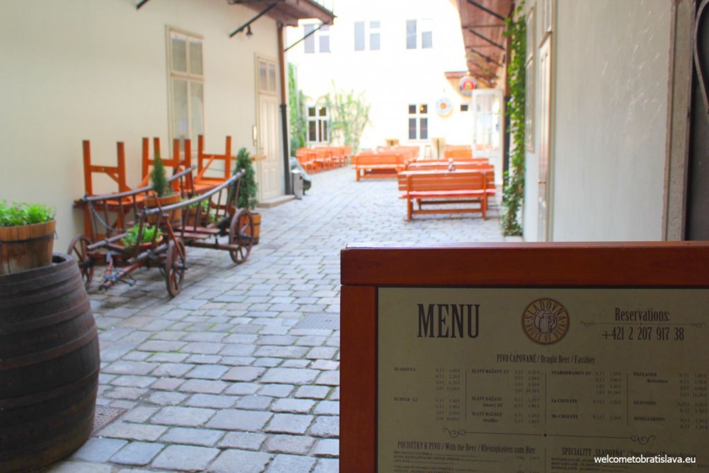 Sladovna's curtilage with a few tables